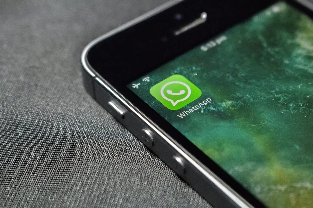 Celular sobre um tecido com o ícone do WhatsApp na tela